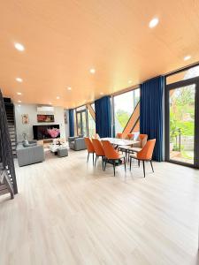 a living room with a dining table and chairs at Uniton Zen Garden in Ấp Bến Cầu