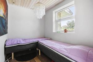 a small bed in a room with a window at SL245-Rude-Fuglevaenget-20 in Rude