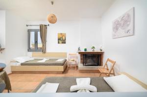 a bedroom with a bed and a fireplace at Hersonissos Villas in Hersonissos +45 photos