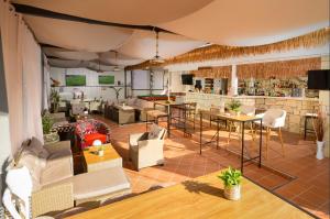 a large room with tables and chairs and a bar at Hersonissos Villas in Hersonissos