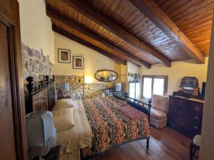 a bedroom with a bed and a chair in a room at Agriturismo Farneto in Farneto