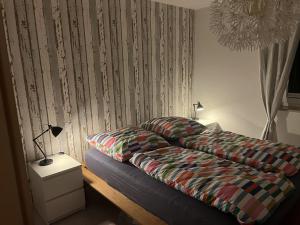 a bedroom with a bed and a table with a lamp at Little Rostock in Papendorf