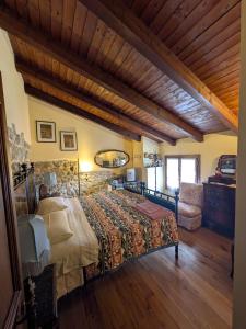 a bedroom with a bed and a stone wall at Agriturismo Farneto in Farneto