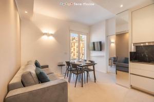 a living room with a couch and a table at Suite Level 8, Terre Marine in La Spezia