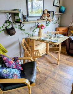 a dining room with a wooden table and chairs at White Pebbles Appartment in Ilfracombe