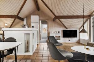 a living room with tables and chairs and a tv at K20063-Store-Fuglede-Ostvej-6 in Store Fuglede