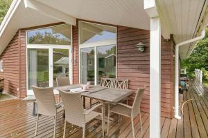 a wooden deck with a table and chairs on it at K19045-Kalundborg-Lobelievej-3 in Kalundborg
