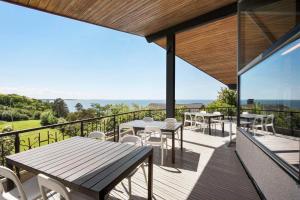 a patio with tables and chairs on a balcony at K19016-Kalundborg-Klintedalsvej-37 in Kalundborg