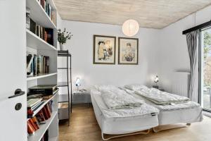 a white bedroom with a bed and bookshelves at K19016-Kalundborg-Klintedalsvej-37 in Kalundborg +53 photos
