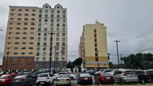 a parking lot full of cars in front of two tall buildings at Cozy Studio Long Stays Welcome in Biñan