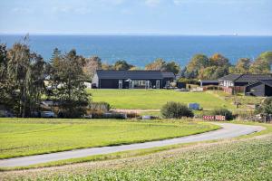 a house on a field with a road in front of it at SL296-Slagelse-Athenesvej-7 in Slagelse
