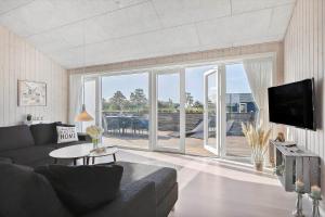 a living room with a couch and a large window at SL296-Slagelse-Athenesvej-7 in Slagelse