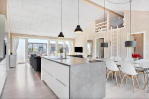 a kitchen and living room with a table and chairs at SL296-Slagelse-Athenesvej-7 in Slagelse +21 photos