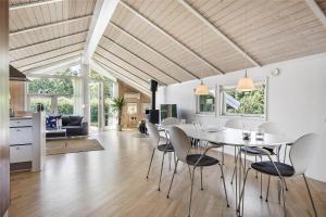 a kitchen and living room with a table and chairs at SL256-Skaelskor-Ostre-Strand-115 in Skælskør