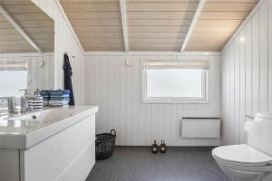 a bathroom with a toilet and a sink and a window at SL256-Skaelskor-Ostre-Strand-115 in Skælskør +24 photos
