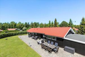 a building with a red roof and a picnic table at SL256-Skaelskor-Ostre-Strand-115 in Skælskør