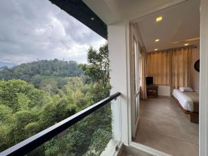 a room with a balcony with a bed and a view at Amrezy Luxury Resort and Spa, Wayanad in Vythiri +54 photos