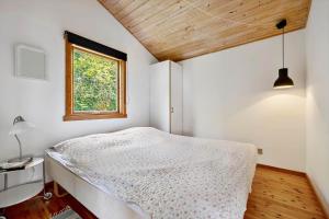 a small bedroom with a bed and a window at SL347-Korsor-Tvaerager-9 in Korsør