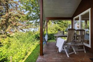 a porch with two chairs and a table on it at SL347-Korsor-Tvaerager-9 in Korsør