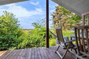 a rocking chair on a porch with a view at SL347-Korsor-Tvaerager-9 in Korsør +12 photos