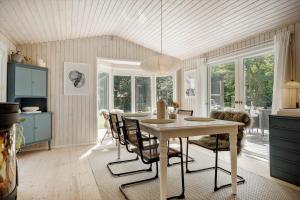 a kitchen with a dining room table and chairs at K20092-Gorlev-Skovhusvej-27 in Gørlev +18 photos