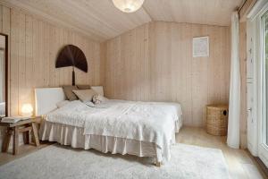 a bedroom with a white bed in a room at K20092-Gorlev-Skovhusvej-27 in Gørlev