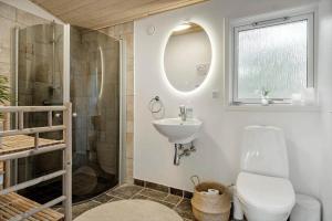 a bathroom with a sink and a toilet and a mirror at K20092-Gorlev-Skovhusvej-27 in Gørlev