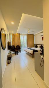 a hotel room with a bed and a mirror at Amrezy Luxury Resort and Spa, Wayanad in Vythiri