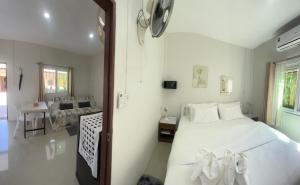 a bedroom with a large white bed and a couch at Yada House s&s in Nai Yang Beach