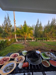 a grill with a bunch of food on it at Kanchana home stay กาญจนา โฮมสเตย์ สุราษฏร์ in Ban Bo Thong