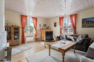 a living room with a couch and a table at KAL097-Gullaskruv-Hetalaga-107 in Gullaskruv