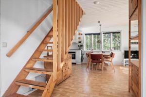 a kitchen and dining room with a wooden staircase in a house at SKA580-Perstorp-Oerahult-708 in Perstorp +21 photos