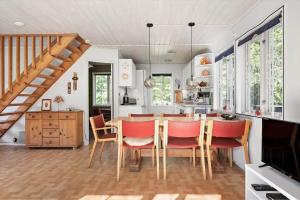 a kitchen and dining room with a table and chairs at SKA580-Perstorp-Oerahult-708 in Perstorp