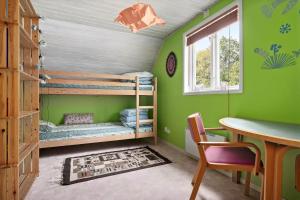 a room with two bunk beds and a table at SKA580-Perstorp-Oerahult-708 in Perstorp