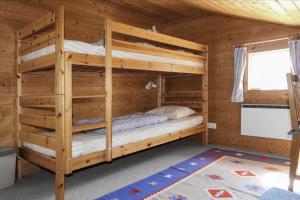 a bedroom with two bunk beds in a log cabin at KAL097-Gullaskruv-Hetalaga-107 in Gullaskruv