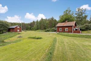 a large field with a house and a barn at KAL097-Gullaskruv-Hetalaga-107 in Gullaskruv