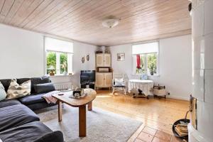 a living room with a couch and a table at KAL159-Gullaskruv-Hetalaga-111 in Gullaskruv