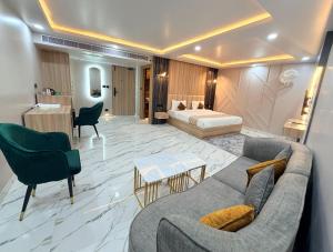 a living room with a couch and a bed at Hotel MEDHA Inn in Patna