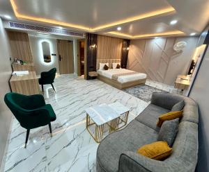 a living room with a couch and a bed at Hotel MEDHA Inn in Patna