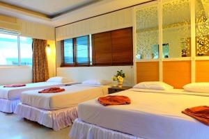 a bedroom with three beds with towels on them at PSHill in Ao Nang Beach