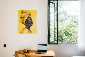 a laptop sitting on a desk next to a window at Santara Villa Ubud in Ubud +37 photos