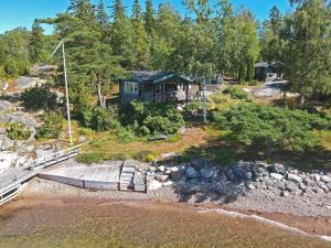 an aerial view of a house next to a river at STO703-Graeddoe-Maroe-77 in Gräddö +12 photos