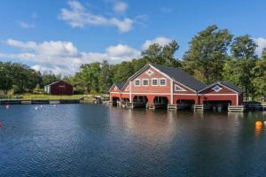 a large red house on the water near a lake at STO703-Graeddoe-Maroe-77 in Gräddö