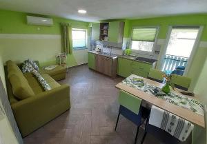 a kitchen and living room with a couch and a table at Hiša Planica in Kobarid