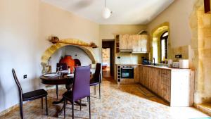a kitchen with a table and a dining room at Villa Andrianna in Frés