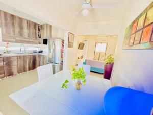a kitchen and dining room with a white table and chairs at Departamento 2 Habitaciones Cas Consulado Centenario in Hermosillo