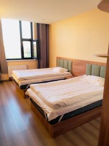two beds in a hotel room with two bedsvisor at Onon-Ulz restaurant and hotel in Uldz