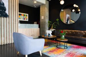 a living room with a couch and a chair at ExpoStay Hotel Corferias Embajada Americana in Bogotá