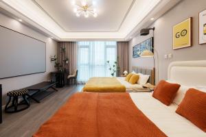 a hotel room with two beds and a projection screen at Shanghai Little 8 Apartment in Shanghai