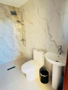 a bathroom with a toilet and a sink at Onon-Ulz restaurant and hotel in Uldz